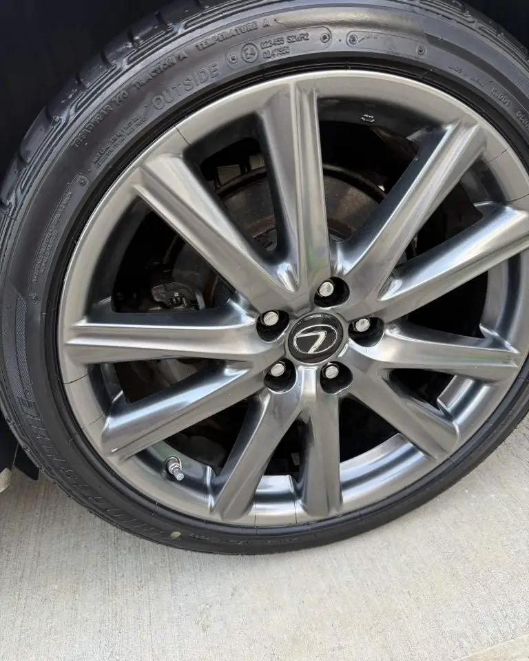 The same Lexus alloy wheel polished to a mirror finish with the tire dressed black